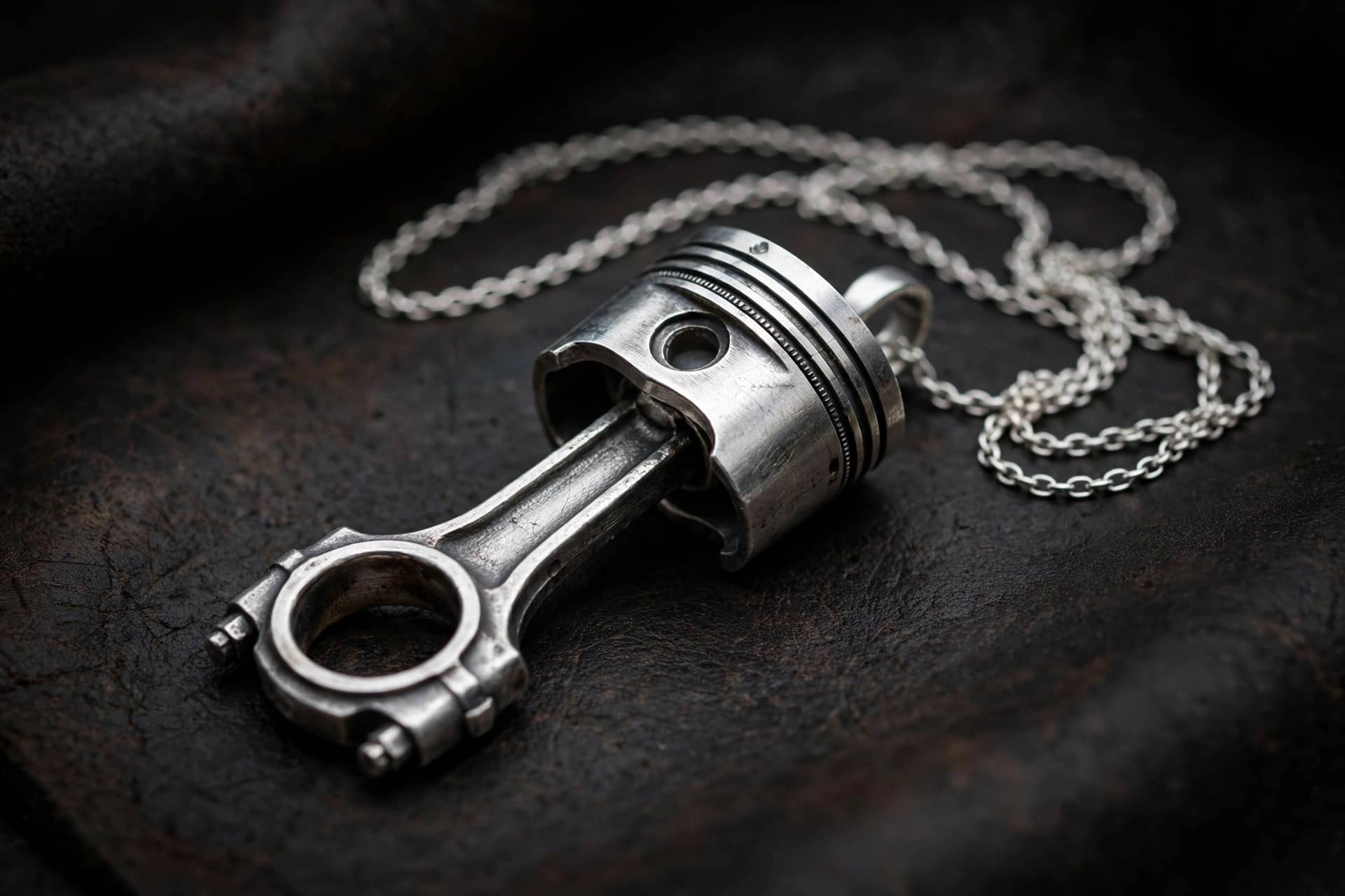 silver piston with connecting rod pendant